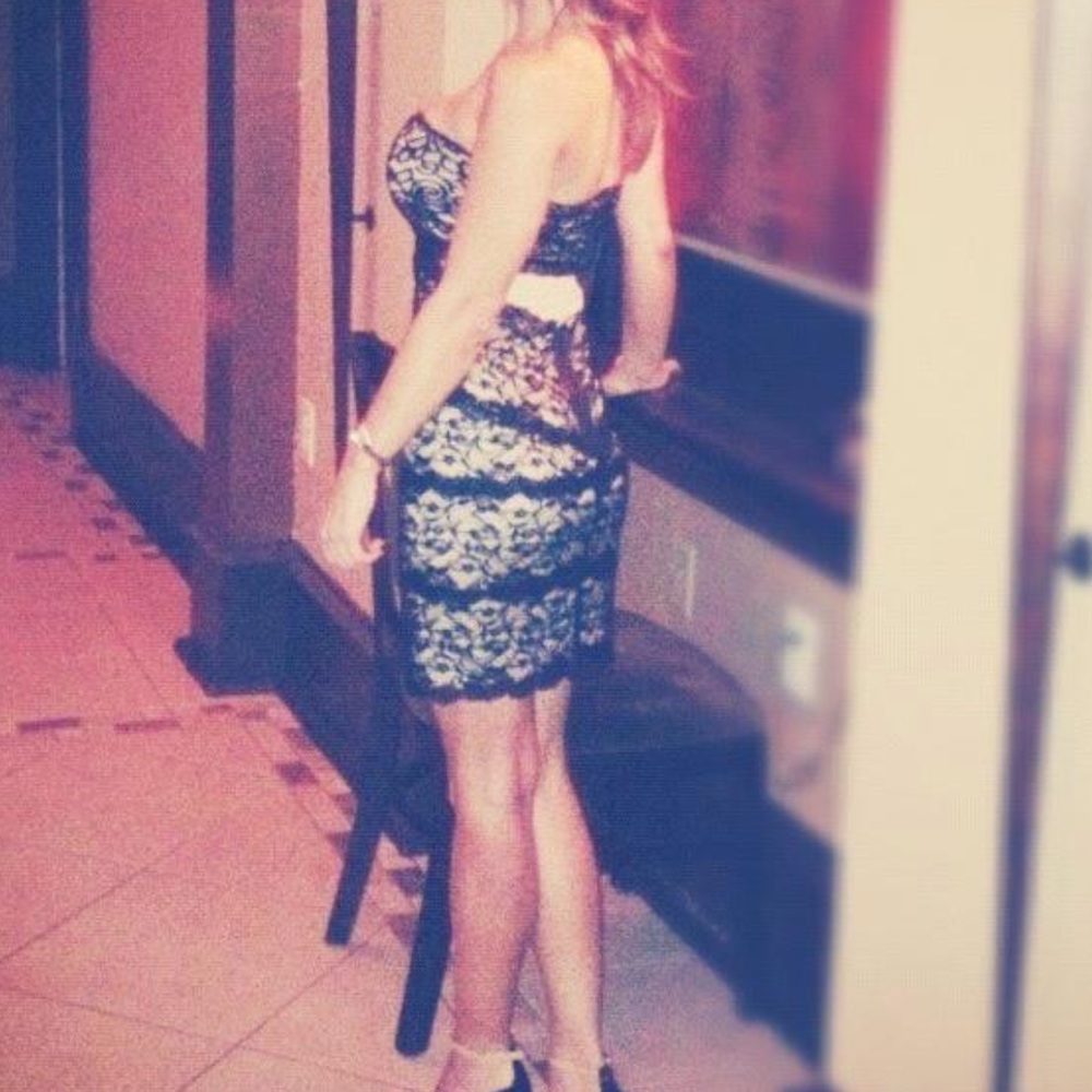 Bebe black lace mini dress over cream colored material. Size XS.